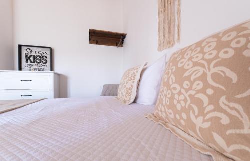 a bedroom with a bed with a pillow and a dresser at Country House - Quinta das 3 Nogueiras in Abitureiras