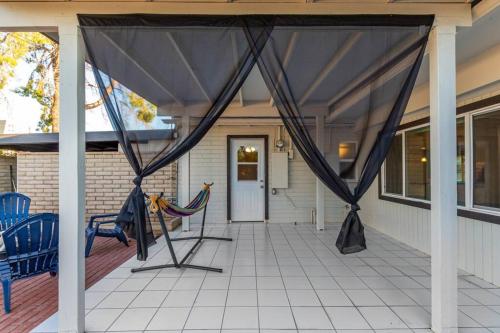 a screened porch with a hammock on a house at New Midtown Studio with Full Kitchen (Unit C) in Phoenix