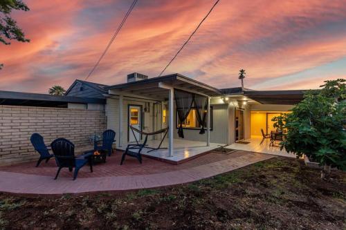 a house with a patio with chairs and a sunset at New Midtown Studio with Full Kitchen (Unit C) in Phoenix