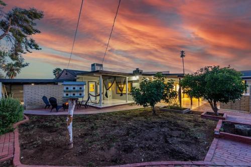 a house with a sunset in the sky at New Midtown Studio with Full Kitchen (Unit C) in Phoenix