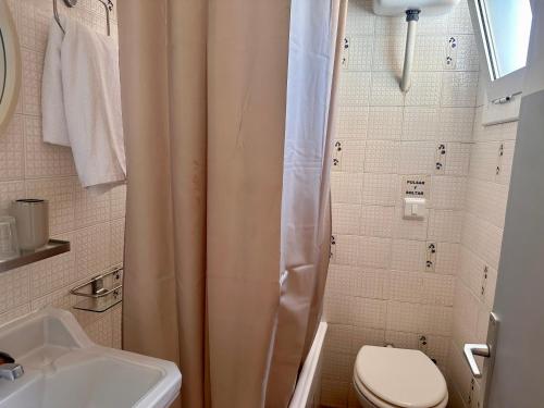 a bathroom with a shower and a toilet and a sink at Can Setmanes by CozyCatalonia in Blanes