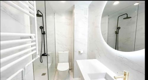 a bathroom with a toilet and a glass shower at Nordic Apartment II Sagrada Familia in Barcelona