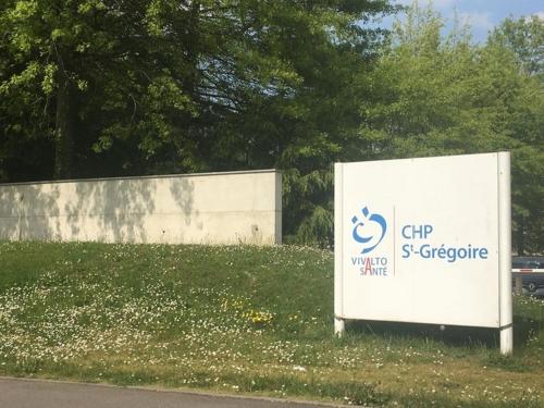 un panneau dans l'herbe devant un bâtiment dans l'établissement ST greg pause, à Rennes