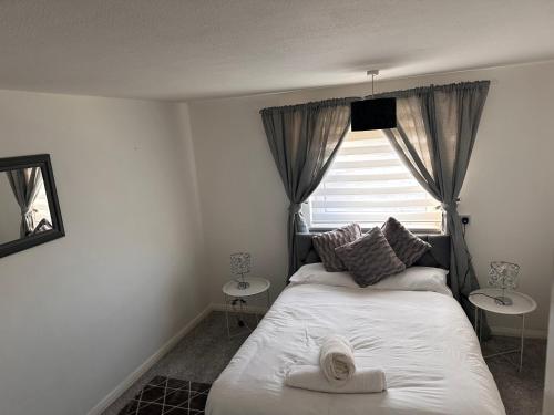 a bedroom with a bed and a window and a mirror at one bed apartment sleeps up to 4 in Ipswich