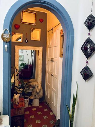 a hallway with an archway with a teddy bear in a room at Lovely cozy & spacious room in heart of Condesa in Mexico City