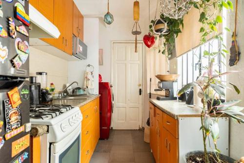 a kitchen with a stove and a refrigerator at Lovely cozy & spacious room in heart of Condesa in Mexico City