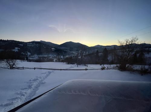 a view of a snow covered field with mountains in the background at CloudBase in Tukhlya
