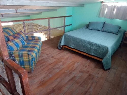 a small bedroom with a bed and a couch at Casita Ukuchay Pcia Bs As in General Belgrano