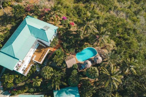 an overhead view of a house and a swimming pool at Amazing mountain top home with pool in Marigot Bay
