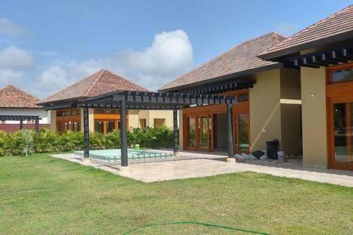 a house with a pool in the yard at Luxury private village Cap Cana in Punta Cana