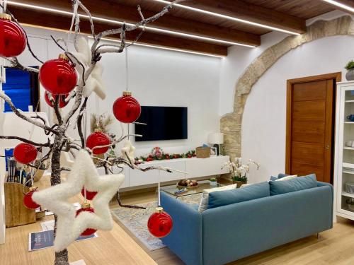a living room with a blue couch and a christmas tree at All’ombra del campanile in Tarquinia