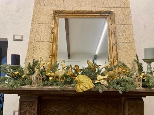a mirror on top of a table with christmas decorations at All’ombra del museo in Tarquinia