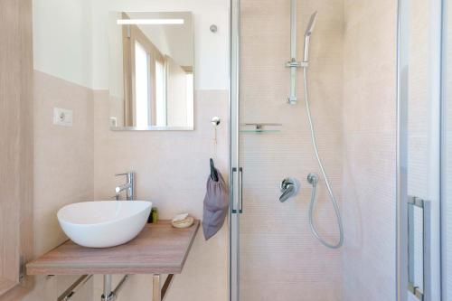 a bathroom with a sink and a shower at TS ROOMS - Guest House Deidda in San Sperate