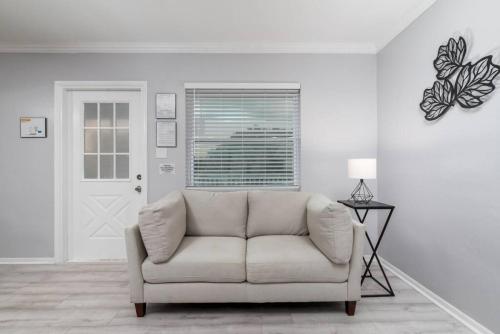 a white living room with a couch and a window at Short Walk to Wilton Drive Apt4 in Fort Lauderdale