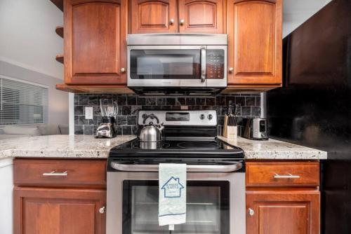 a kitchen with a stove and a microwave at Short Walk to Wilton Drive Apt4 in Fort Lauderdale