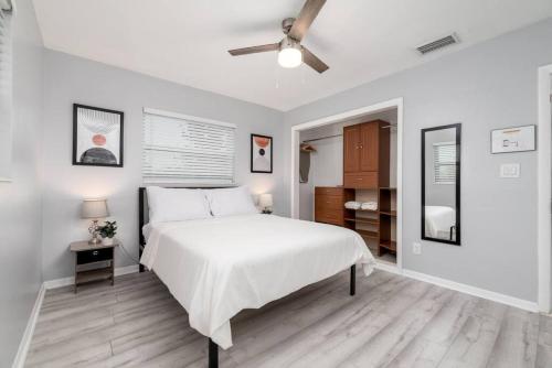 a bedroom with a white bed and a ceiling fan at Short Walk to Wilton Drive Apt4 in Fort Lauderdale