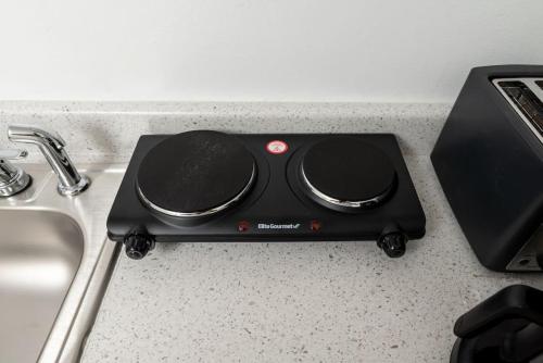 a black appliance sitting on a counter next to a sink at Short Walk to Wilton Drive Apt6 in Fort Lauderdale