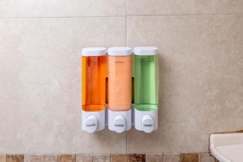 a group of four colored cups on the wall at Short Walk to Wilton Drive Apt6 in Fort Lauderdale