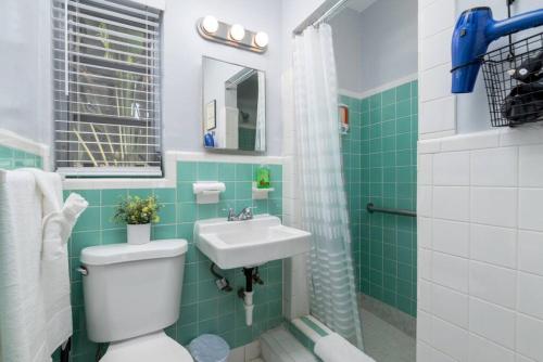a bathroom with a toilet and a sink at The Dolphin Studio at Lake Ridge in Fort Lauderdale