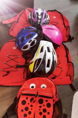 a pile of helmets and backpacks on the floor at Csucsu Vendégház in Mád