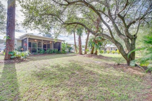 a house with trees in front of a yard at Sebastian Home with Screened Lanai 8 Mi to Beach! in Sebastian