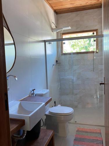 a bathroom with a sink and a toilet and a shower at Cabana das Mandalas in Itacaré