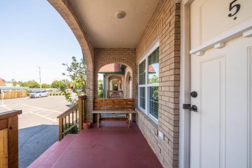 a porch with a bench on the side of a building at Best Court in Hot Springs