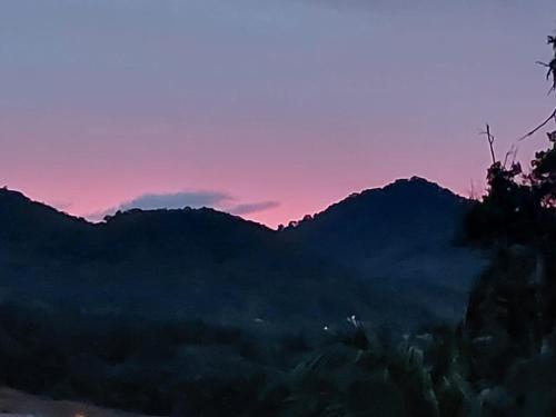 a view of a mountain range at sunset at loft harmonia in Blumenau