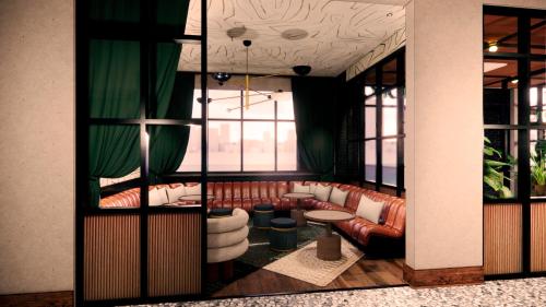 a living room with couches and a window at Motto By Hilton Bentonville Downtown in Bentonville