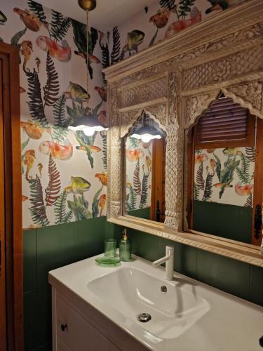 a bathroom with a sink and a mirror at Apartahotel La Chipranera in Castejón de Monegros