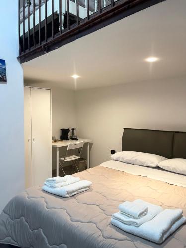 a bedroom with a bed with towels on it at House Caracciolo by Loveinthetravel in Naples