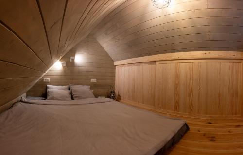 a bedroom with a large bed in a wooden wall at Satori Lounge in Lublin