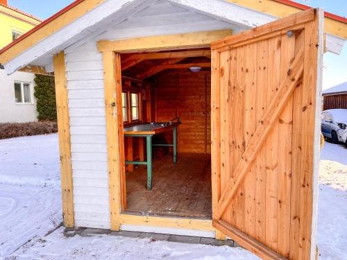a wooden shed with a ping pong table in it at Vandrarhemmet Stranden in Mora