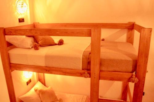 a level bunk bed with a teddy bear on it at TRAVEL SURF NATURE in Tamraght Ouzdar