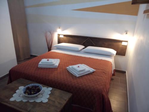 a hotel room with a bed with a bowl of fruit on it at Bed And Breakfasts LA CASETTA in Terranova di Pollino