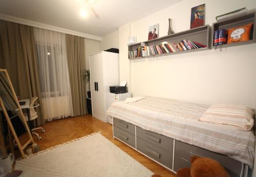 - une chambre avec un lit et des étagères sur le mur dans l'établissement Shared apartment at Şişli(private room), à Istanbul