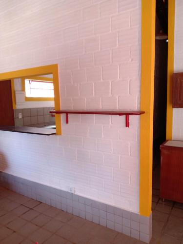 a brick wall with a shelf in a room at CASA EM PORTO in Porto De Galinhas