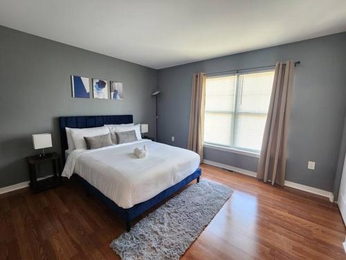 a bedroom with a large bed and a window at The Grey Escape-Close to Beach Waterpark & Casinos in Atlantic City