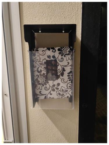 a black and white box on a wall at PIGRO House - Bologna Airport Suite in Bologna
