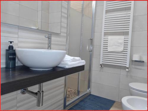 łazienka z białą umywalką i toaletą w obiekcie PIGRO House - Bologna Airport Suite w Bolonii