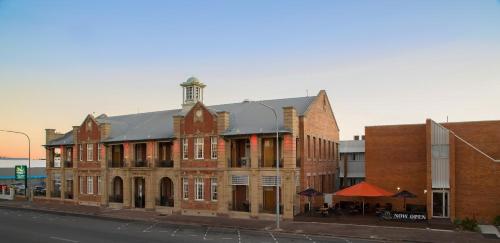 a large brick building on the side of a street at Quality Hotel Regent Rockhampton in Rockhampton