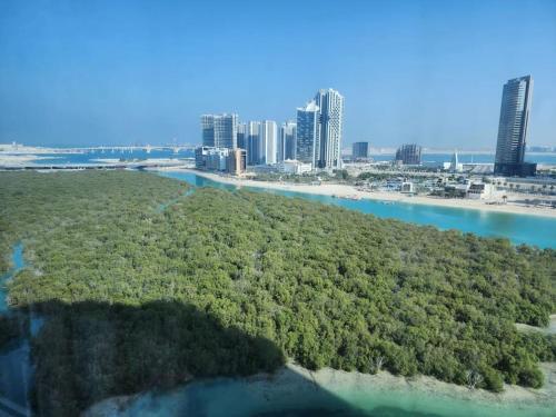 an island in the water with a city in the background at HARF4606 Huge water front 1BR Apt with 2 Sofa Beds in Alreem Island in Abu Dhabi