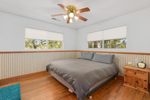 a bedroom with a bed and a ceiling fan at Astonishing Flagstaff Flat with AC and Jacuzzi! in Flagstaff