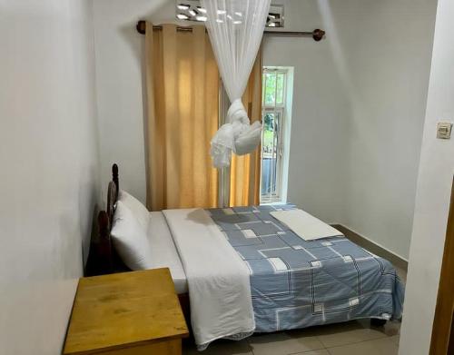 a bedroom with a bed and a window at Charming 4-Bed House in Kigali in Kigali