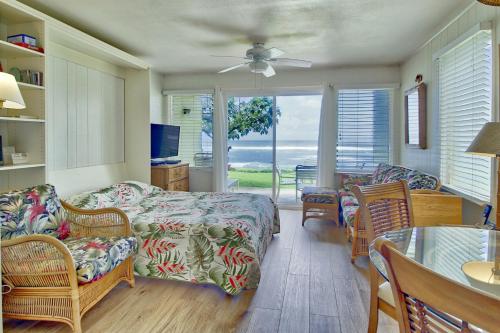 een woonkamer met een bank, stoelen en een tafel bij Kapa'a Sands 08 in Kapaa