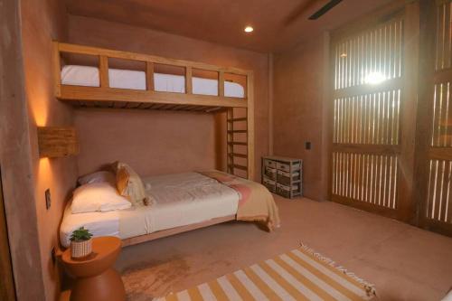 a bedroom with a bed and a large window at Increíble Casa frente a la playa in Puerto Escondido