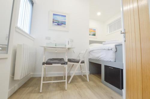 a small room with a desk and a bed at Viewpoint West in Dunollie