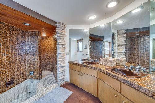 a bathroom with two sinks and a large mirror at Eclectic Hubertus Home with Game Room and Fire Pit! in Germantown