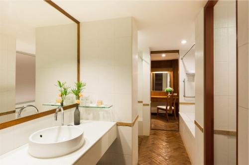 a bathroom with a sink and a mirror at Eastern Grand Palace in Pattaya South