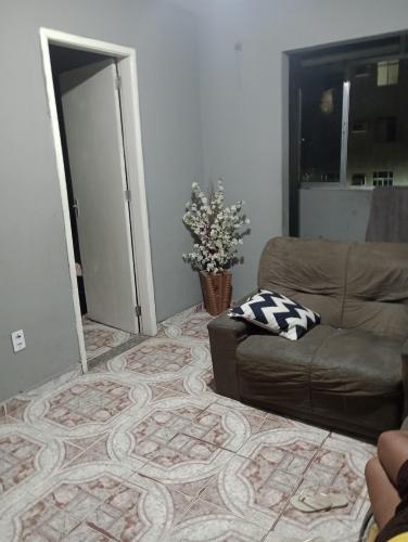 a living room with a couch and a door open at Casa Penha in Rio de Janeiro